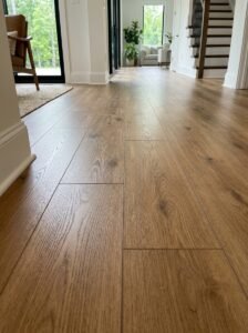 Mix hardwood and LVP flooring transition in a modern living room